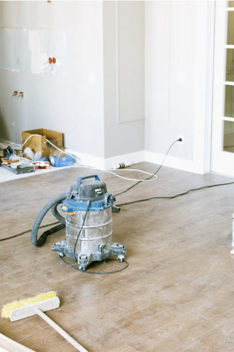 Placeholder photo — a shop vac and tools mid-cleanup in a room under renovation. Swap for a real Magic Maids job-site photo.